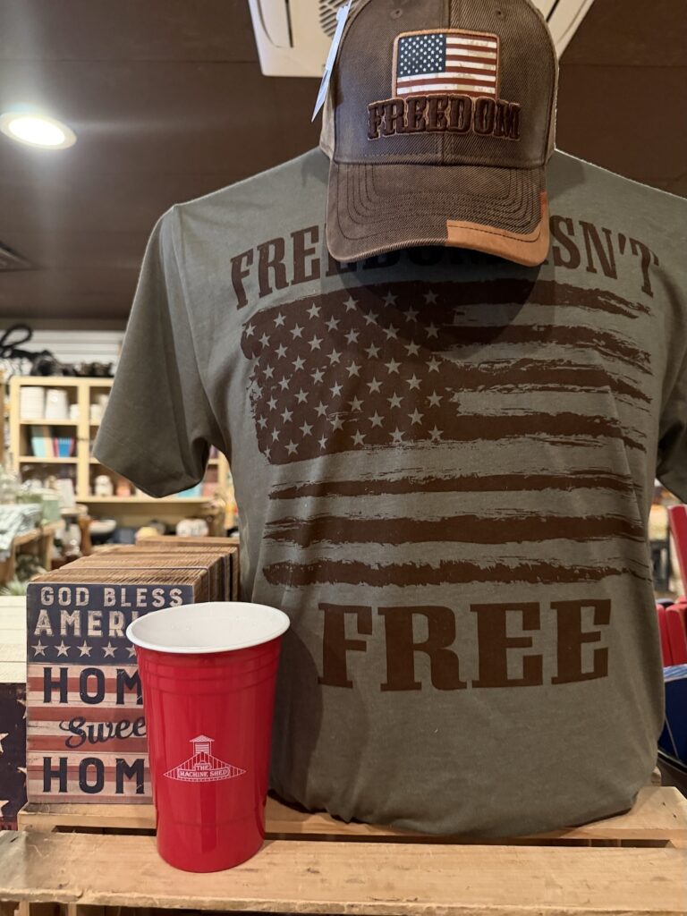 Machine Shed Gift Shop Freedom and Flag themed apparel and sign