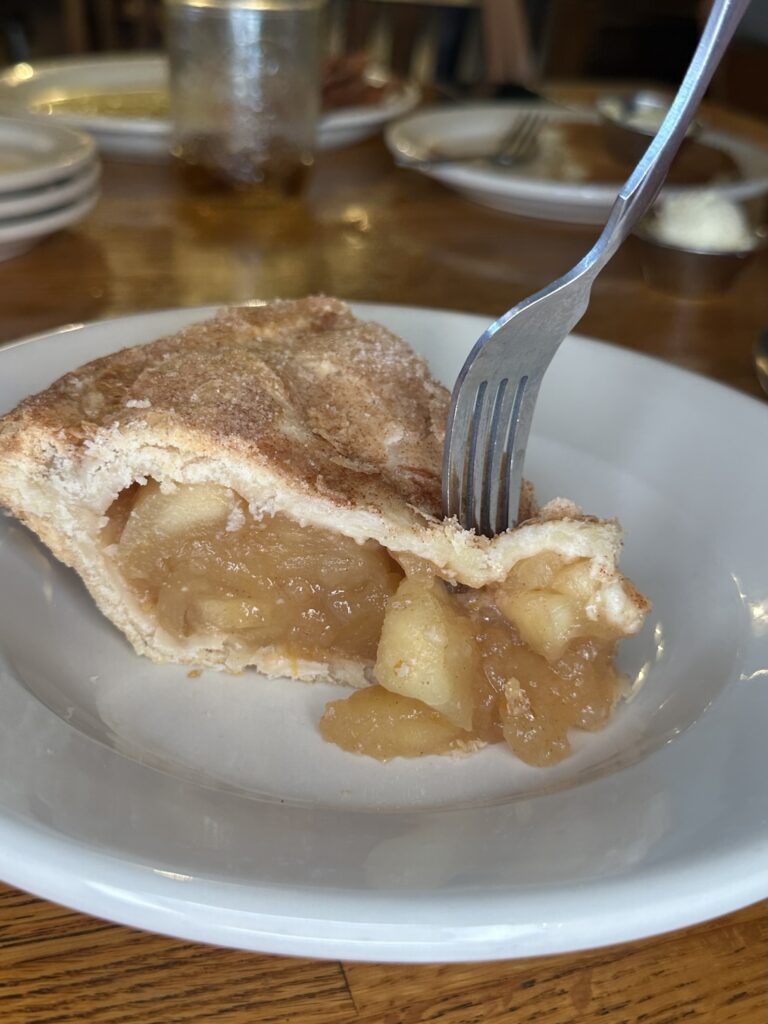 Machine Shed Apple pie with a fork in the middle of taking a piece